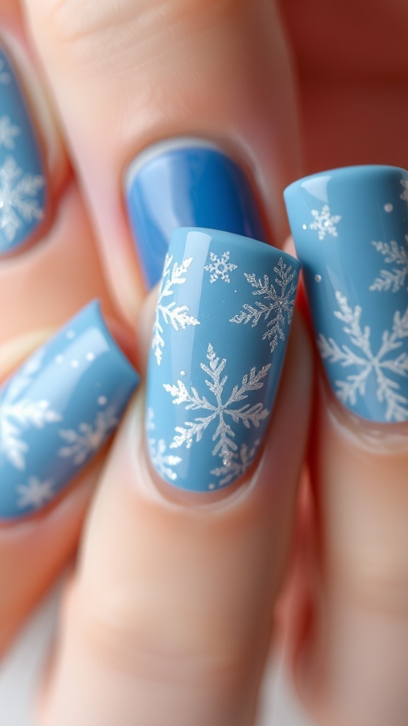 Winter-themed blue Christmas nail art with snowflakes and glitter.